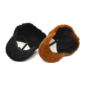 Winter plush baseball caps in black and caramel brown featuring warm faux fur texture