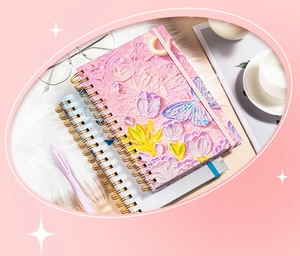 Detailed relief texture of floral oil painting cover on a pink A5 spiral notebook