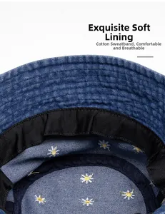 Close-up of denim bucket hat interior with daisy embroidery lining and cotton sweatband