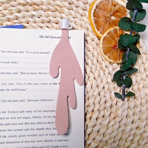 Detailed view of creative pink leather bookmark on book pages with artistic decor