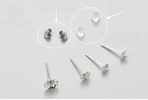 Macro shot of S925 sterling silver plum flower stud earring base with metal and silicone plugs