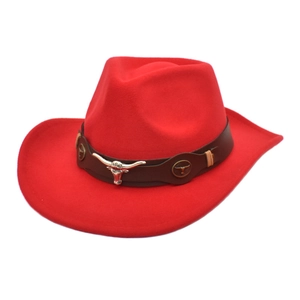 Detail of red western cowboy hat with brown leather band and metal bull head ornament