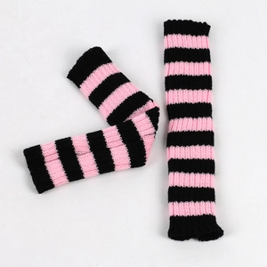 Detail shot of striped knitted fingerless gloves in black and pink for winter warmth