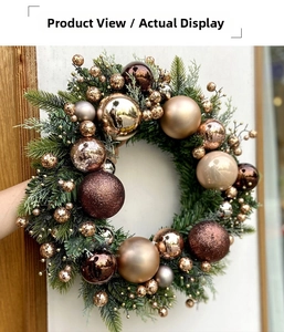 Detail of Christmas wreath with champagne gold and coffee ornaments on pine needles