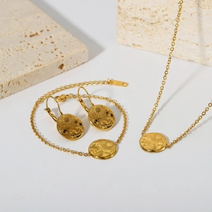 Detail of 18K gold-plated jewelry set with sun, moon, and star relief engraving patterns