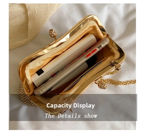 Detail view of rhinestone evening clutch interior with chain and storage space