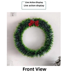 Detail of green laser tinsel Christmas wreath featuring a decorative red bow for festive decor