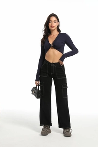 Detail of high-waisted black wide-leg cargo pants with contrast stitching and loose fit