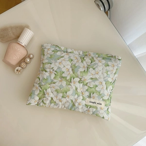 Quilted floral makeup pouch in green and white with a simple wish fabric label