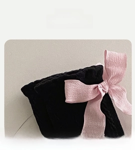 Detail view of high elasticity black sock mouth with a light pink satin ribbon bow