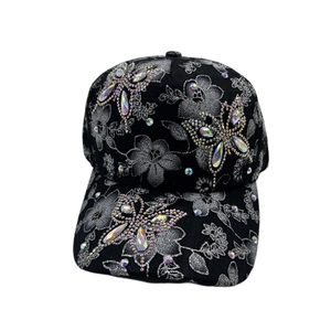Detailed view of rhinestone butterfly and floral embroidery on a black baseball cap