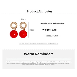 Detail showing red ball drop earrings with faux pearls and size dimensions in centimeters