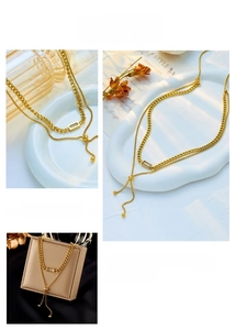 Adjustable double-layered gold chain necklace with a rectangular crystal pendant and bead slider