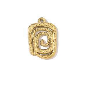 Detail of a textured golden rectangular pendant featuring a spiral hollow pattern
