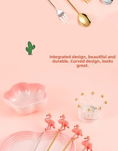 Detail view of pink flamingo dessert forks set with decorative crown glass and floral bowl