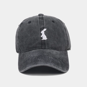Detailed embroidery of white rabbit silhouette on dark gray washed cotton baseball cap