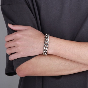 Close-up of 12mm stainless steel Cuban link chain bracelet on wrist for men