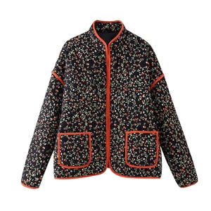 Detail of quilted floral cotton jacket featuring orange trim and front pockets