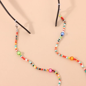 Macro shot of colorful acrylic beads and silver lobster clasp on an eyewear chain