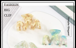 Detailed macro view of acetate hair claw clip featuring colorful marble texture and wave design