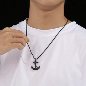 Retro black nautical anchor pendant necklace for men with black braided rope chain on model