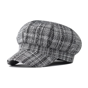 Classic black and white checkered newsboy cap for women in a retro autumn winter style