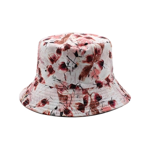 Close-up of floral print cotton bucket hat with detailed stitching on light beige fabric