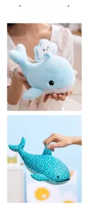 Detail of plush whale and whale shark toys with cloud pattern and white polka dots