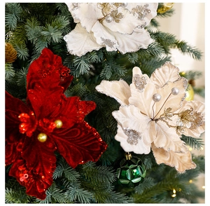 Close-up of velvet poinsettia flowers with glitter on Christmas tree branches