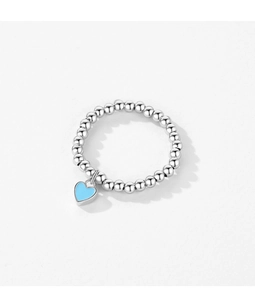 Close-up of s925 silver beaded ring featuring a blue enamel heart charm on white background