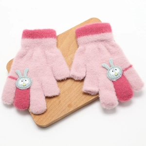 Pink knitted convertible kids gloves with rabbit patch on a wooden tray