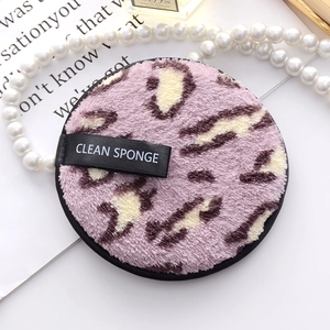 Pink leopard print microfiber cleansing puff with a black ribbon handle and soft texture