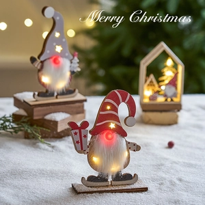 LED lighted wooden Christmas gnome ornament with warm glow and snowy festive background