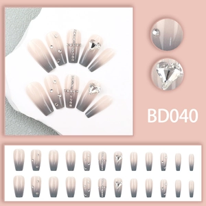 Close-up of coffin shape ombre nails with heart rhinestones and silver cross details
