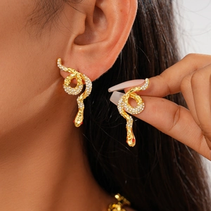 Luxurious gold snake earrings with sparkling clear crystals and red rhinestone eyes