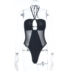 Detail of black halter bodysuit showing ribbed fabric and sheer mesh side panels