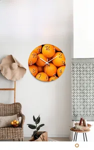 Detail of round wall clock with orange pattern dial and relief numbers in Nordic room