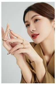 Detail of gold double-ring set with micro-pave zircons on a professional fashion model