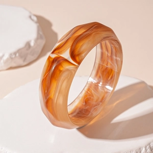 Macro shot of retro acrylic resin bracelet with amber texture and striped patterns