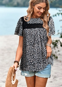 Detail of leopard print blouse featuring black lace crochet hollow out sleeves and shoulders