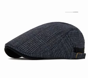Detailed view of deep gray newsboy cap featuring plaid wool texture and metal side buckle