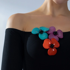 Three-color acrylic 3D flower brooch in teal purple and orange on a black dress