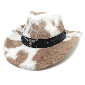 Plush cow print cowboy hat with faux fur texture and longhorn skull leather band