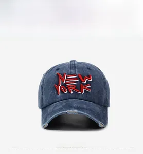 Detail of distressed brim and vintage New York 3D embroidery on washed denim baseball cap