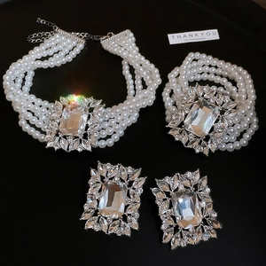 Detail of luxury multi-layer pearl jewelry set with zircon and large crystal stones