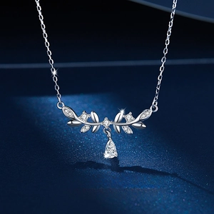 Macro shot of silver laurel leaf necklace with sparkling crystals and water drop pendant