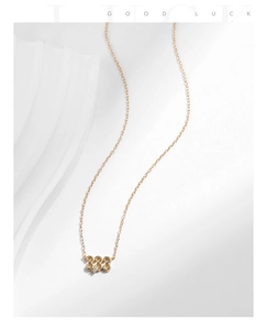 Close-up of gold S925 sterling silver 333 number pendant with a small zircon stone