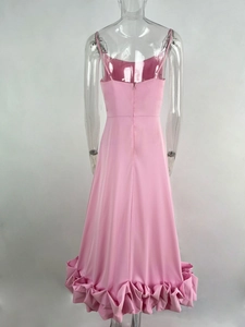 Detail of pink spaghetti strap dress back with invisible zipper and tiered ruffle hem