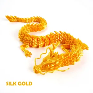 Detailed macro view of a 3D printed articulated dragon in silk gold finish with scales