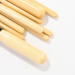 Detail of natural wood makeup brush handles with smooth polished finish and rounded ends